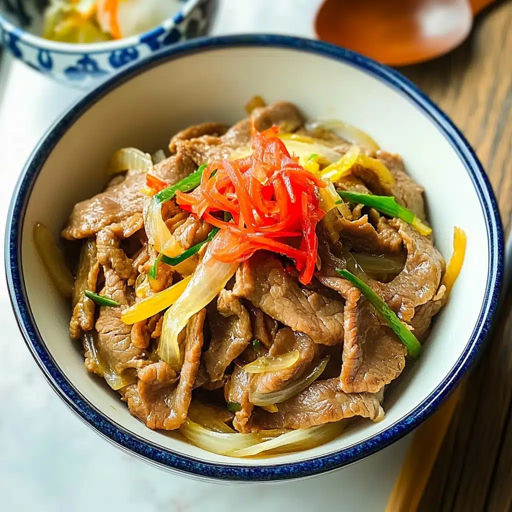 Gyudon Japanese Beef Rice Bowl, Japanese beef bowl recipe, easy Gyudon recipe, homemade Gyudon, quick Japanese comfort food The dish is served in a white bowl with a thin blue rim, filled with thinly sliced cooked meat that is light brown with a tender texture, mixed with translucent yellow onion slices and bright green scallions. On top, there is a small heap of finely sliced bright red pickled ginger adding a pop of color. The bowl is placed on a white marbled surface, next to a wooden spoon and a pair of chopsticks with red and white details. Part of a white bowl with blue patterns is visible on the side, slightly open.