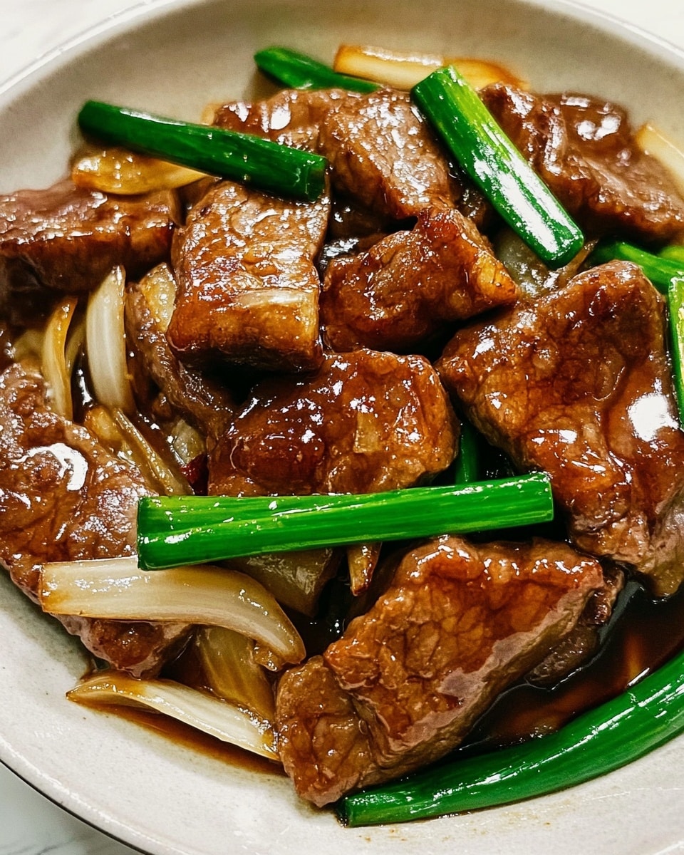 Thin, shiny brown pieces of cooked meat form the top layer, coated with a glossy sauce. Underneath and mixed with the meat are long strips of light yellow-brown onions and bright green parts of green onions. The dish is served in a white plate, set on a white marbled surface. Photo taken with an iphone --ar 4:5 --v 6.1
