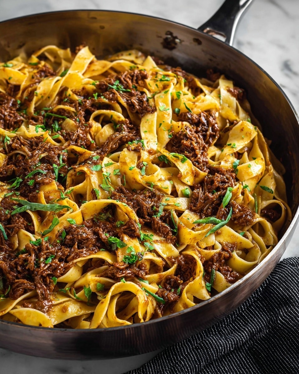 The dish shows soft, flat pasta noodles piled in a white bowl, mixed with chunks of dark brown shredded meat. The noodles are yellowish with a slightly oily shine, twisted around a silver fork that’s lifting a bite. Small green herb pieces are sprinkled across the dish with tiny white grated bits on top, giving a fresh look. The bowl sits on a white marbled surface. photo taken with an iphone --ar 4:5 --v 7