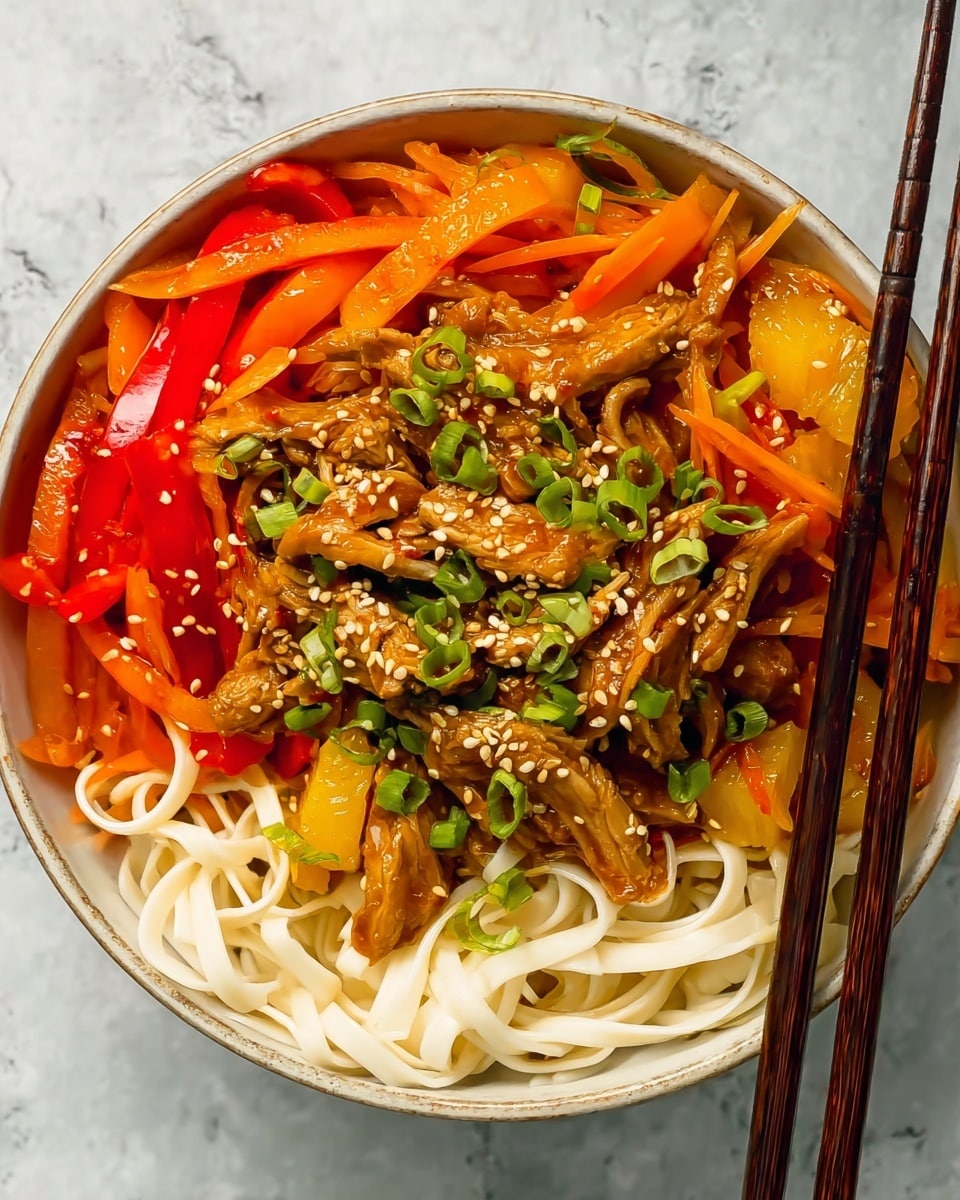 A white shallow bowl filled with thick, flat white noodles forming the base layer with smooth texture. On top, there is a mix of tender cooked chicken pieces colored golden brown, scattered with bright orange bell pepper strips and translucent light yellow pineapple chunks. The dish is garnished with fresh green sliced scallions and sprinkled with light toasted sesame seeds. Resting on the edge of the bowl are medium brown wooden chopsticks. The background shows a white marbled texture. photo taken with an iphone --ar 4:5 --v 7