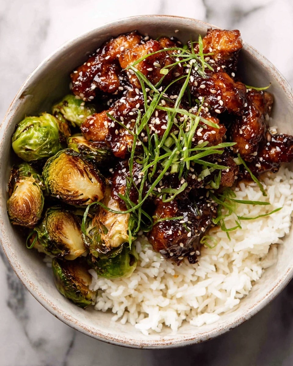 A white bowl filled with three main layers: the bottom layer is plain white rice showing individual soft grains, the middle layer is roasted Brussels sprouts with a slightly browned, crispy texture, and the top layer is sticky, dark brown glazed pieces of chicken sprinkled with white sesame seeds and thin green scallion strips scattered over the chicken. The bowl sits on a white marbled surface. Photo taken with an iphone --ar 4:5 --v 7