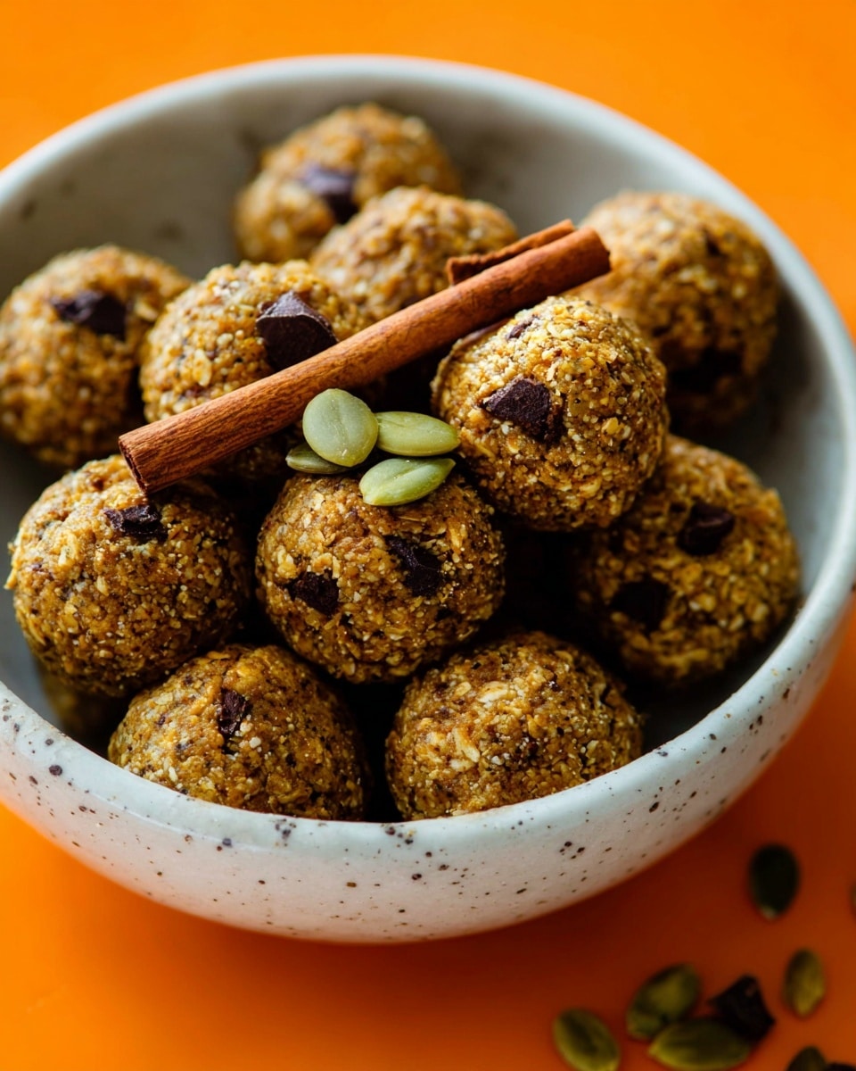 A white bowl filled with many round energy bites made of oats and small chocolate pieces, showing a rough texture with visible grains. Some bites have a small green pumpkin seed on top. In the center, there are three cinnamon sticks, two lying flat and one standing upright. The background has a white marbled texture beneath the bowl. photo taken with an iphone --ar 4:5 --v 7