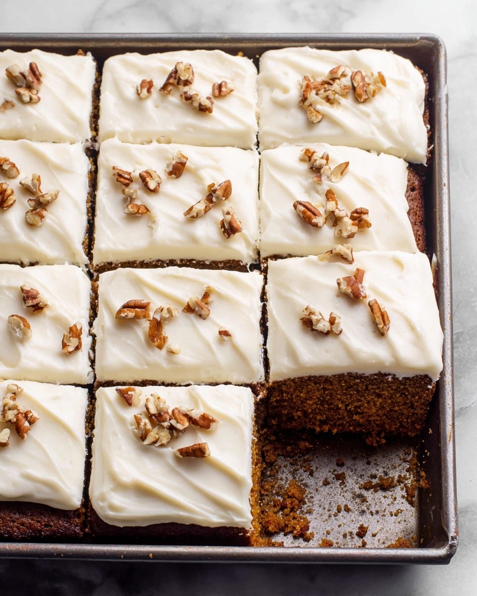 A single square piece of orange-brown cake sits on a white plate with small decorative edges. The cake has one thick layer of moist texture and a smooth white frosting layer on top. Scattered on the frosting are small pieces of brown pecans. Near the plate is a silver fork with three wide prongs, and the background is a white marbled surface. Photo taken with an iphone --ar 4:5 --v 7