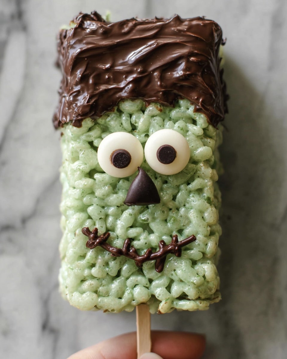 A rectangular shaped rice treat colored pale green forms the base of this crispy dessert. It is topped with a thick layer of melted brown chocolate that looks smooth and slightly shiny, covering the top part like hair. Two round candy eyes with white and black centers are set near the top center on the green rice, giving the treat a face. Thin lines of chocolate create eyebrows above the eyes and a mouth below them, with a smiling curve and some decorative squiggles on the right side. Two dark brown chocolate chips are placed on either side, acting like ears. The treat is placed on a white marbled surface, with a skewer held by a woman's hand pointing towards the mouth on the right side. The overall look resembles a fun monster or character made with rice treats and chocolate. photo taken with an iphone --ar 4:5 --v 7
