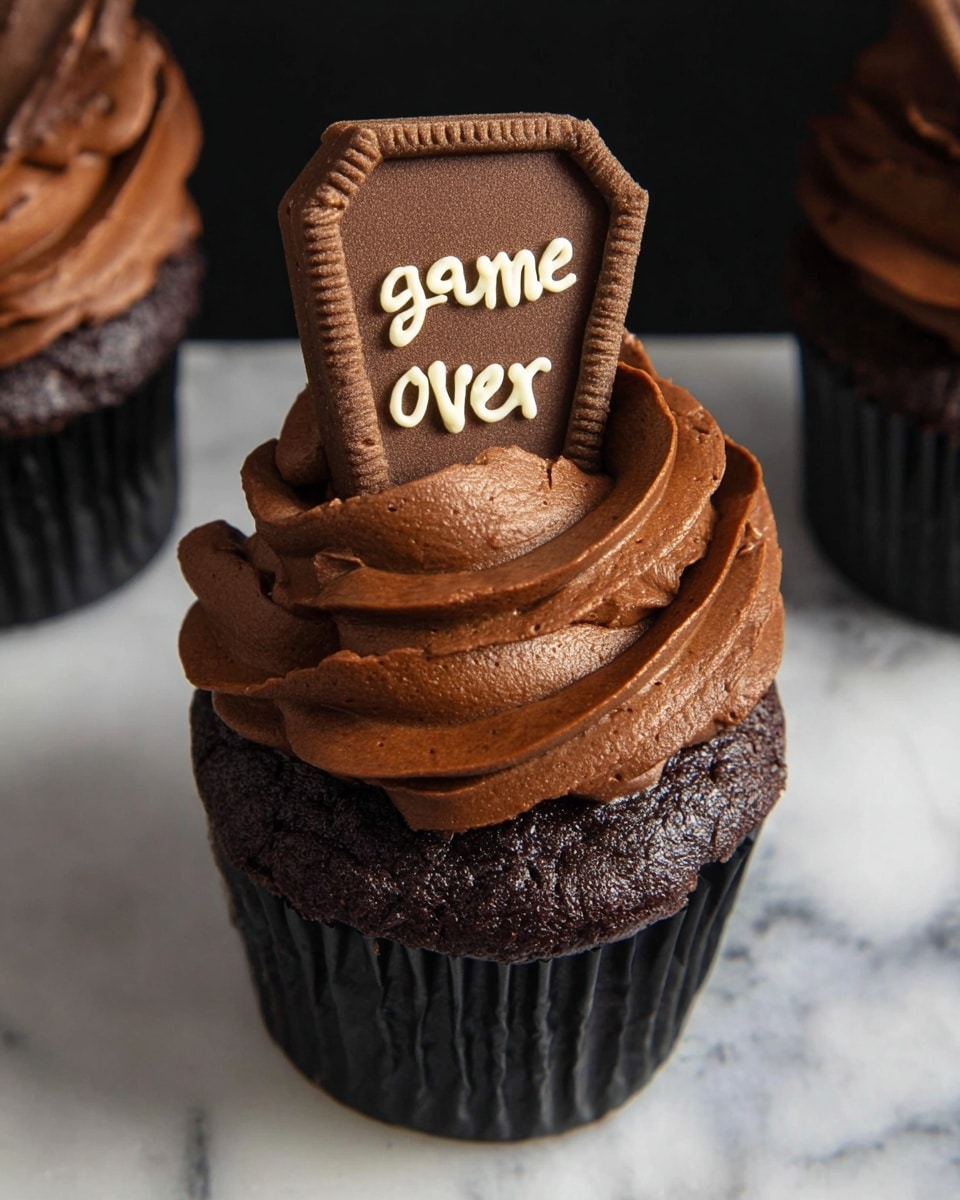 Seven chocolate cupcakes sit arranged on a round wooden board with bark edges. Each cupcake has one thick swirl of smooth, dark chocolate frosting on top. Sticking upright in the frosting of each cupcake is a rectangular chocolate cookie decorated with uneven white icing letters forming short phrases like