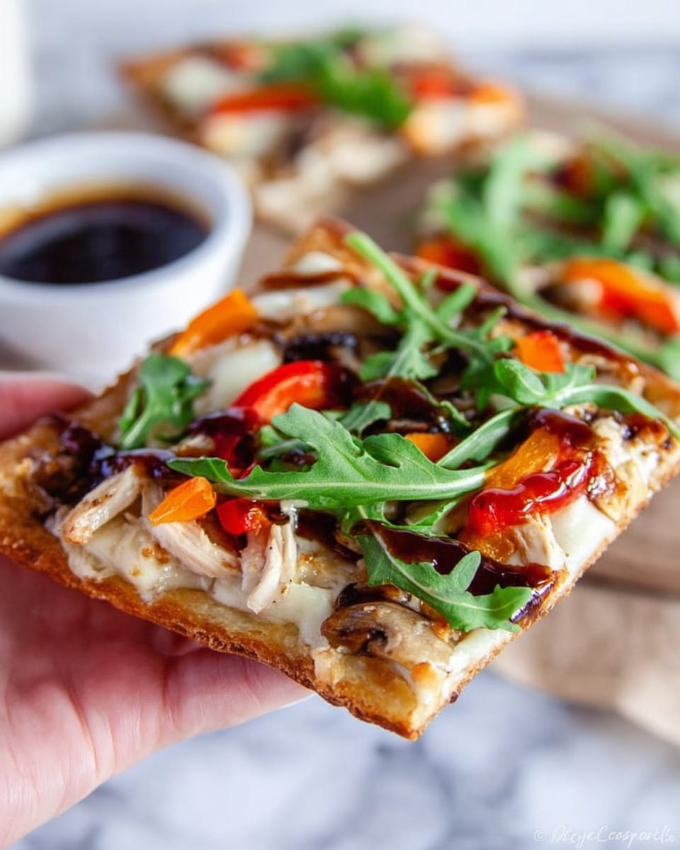 The image shows a square flatbread pizza with a golden-brown, slightly crispy crust. The first layer is a dark brown sauce spread evenly across the crust, topped with thin slices of white cheese that are slightly melted. On top of the cheese are pieces of light beige cooked chicken, slices of brown mushrooms, and red and orange bell pepper rings. Fresh green arugula leaves are scattered on the top, adding a touch of vibrant green. The pizza is placed on a blue and gray patterned cloth, resting on a white marbled surface. Photo taken with an iphone --ar 4:5 --v 7
