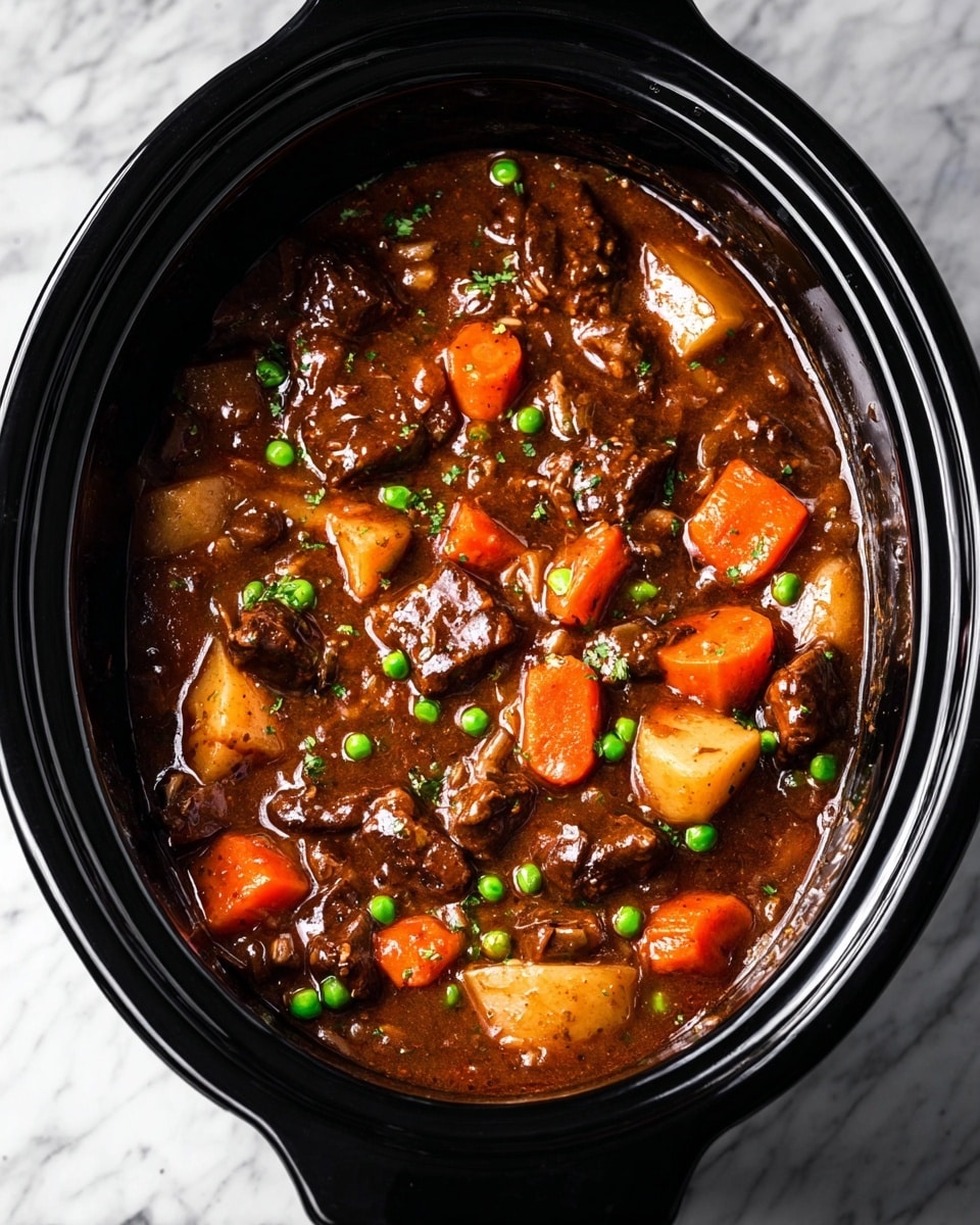 The image shows a slow cooker filled with a thick stew that has a rich brown sauce as the base layer, pot-stewed chunks of dark brown meat scattered throughout, bright orange carrot slices and small green peas evenly distributed, and pale chunks of potatoes and onions mixed in. The slow cooker is black, and it sits on a white marbled surface. The stew has a glossy texture with visible bits of seasoning and vegetables in the sauce, filling the cooker almost to the top. Photo taken with an iphone --ar 4:5 --v 7