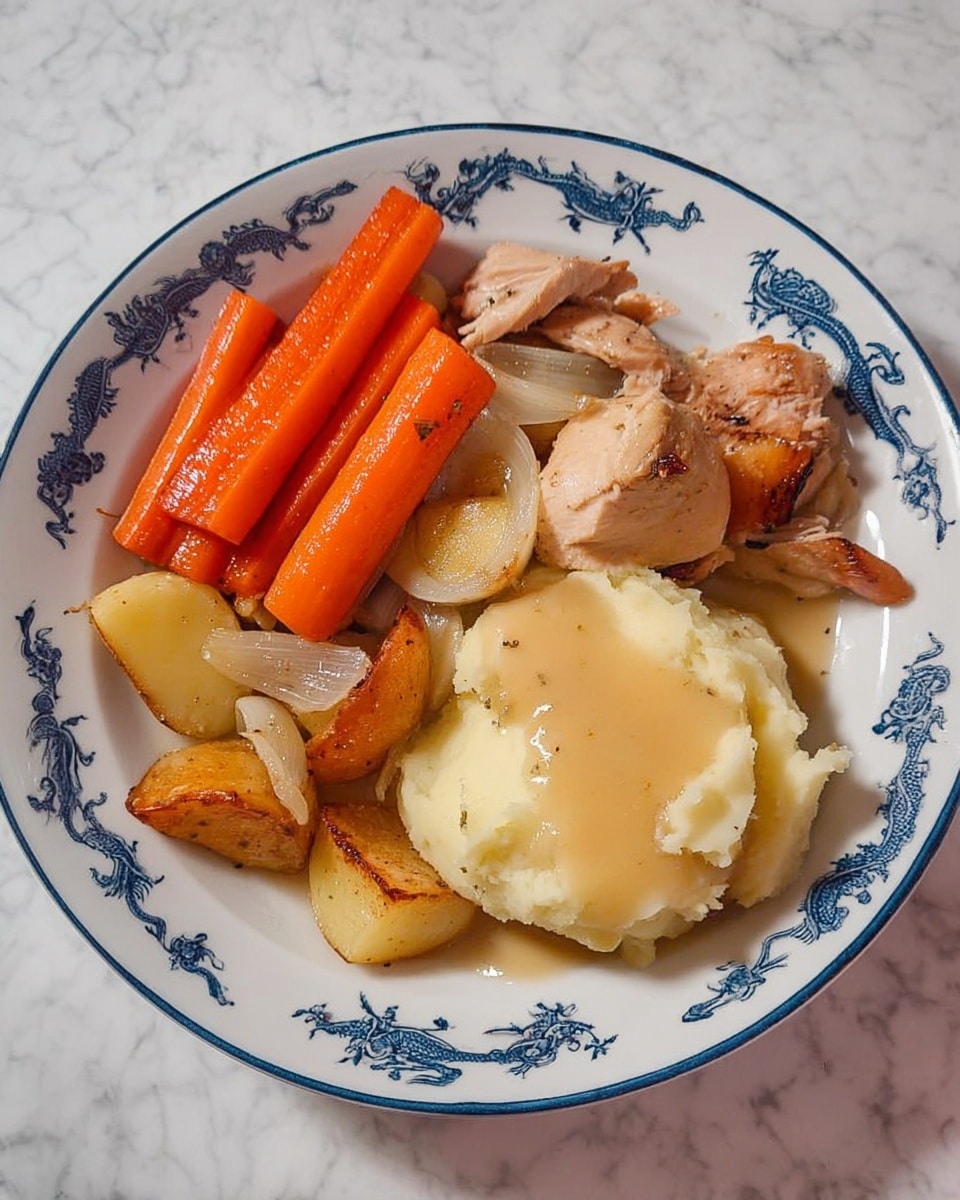 The dish is served on a white plate with blue dragon patterns along the rim, placed on a white marbled surface. It has four main parts: three bright orange carrot sticks positioned at the top, a cluster of light brown roasted onions and small golden potato wedges mixed near the center-left, two pieces of cooked chicken with a light brown color underneath the onions and potatoes, and a creamy, pale yellow mashed potato mound with some light brown gravy on top located at the center-right. The textures range from smooth mashed potatoes to soft roasted vegetables and tender chicken. Photo taken with an iphone --ar 4:5 --v 7
