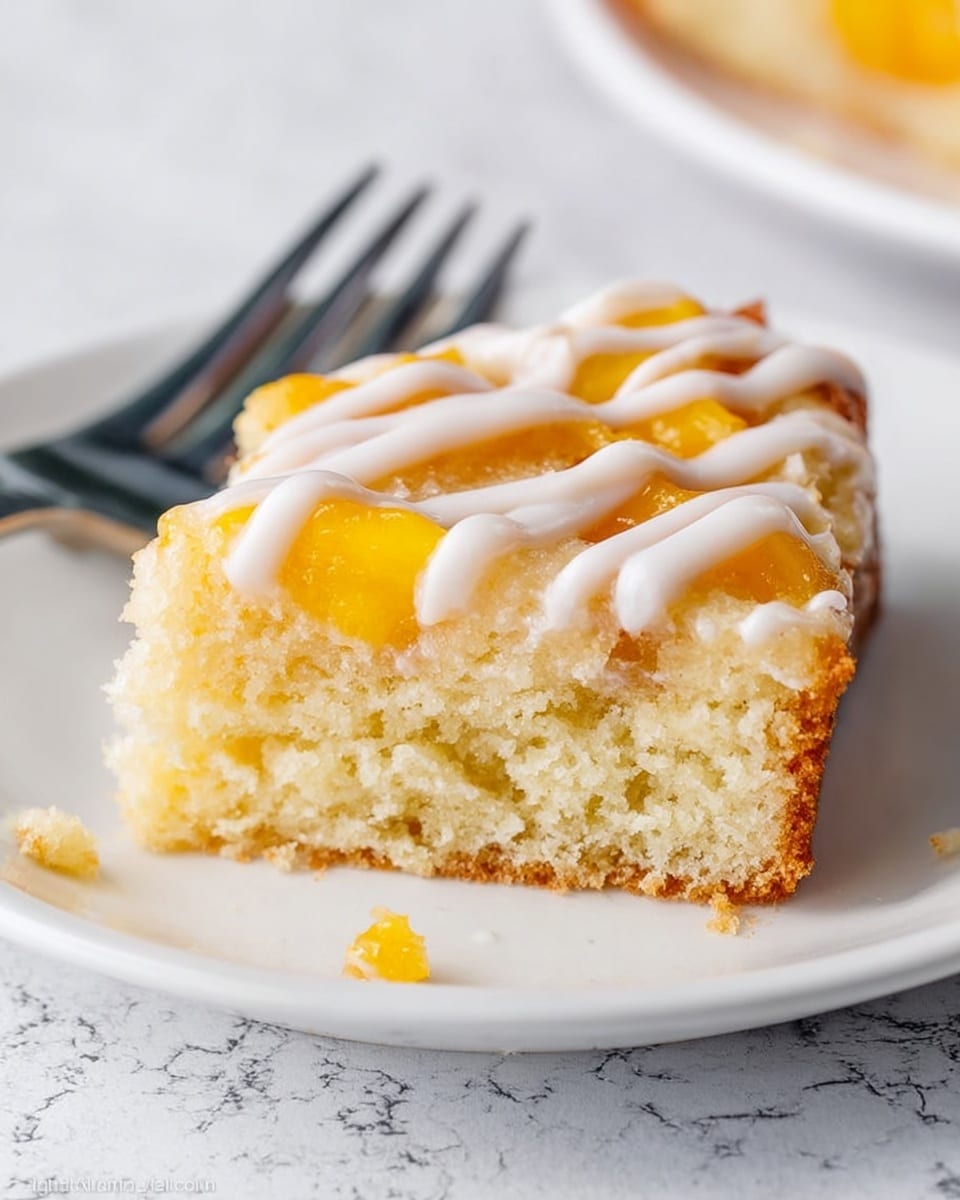 A square slice of peach dessert bar is centered on a white plate with two stacked white plates underneath. The dessert has three layers: a thick, crumbly beige base, a middle layer with bright orange peach pieces, and a crumbly golden top with chunks of fruit. White icing is drizzled on top in a loose grid pattern. In the background, more slices of the dessert are on a baking tray, and a few peach slices are beside the plate on a light, white marbled surface. Photo taken with an iphone --ar 4:5 --v 7