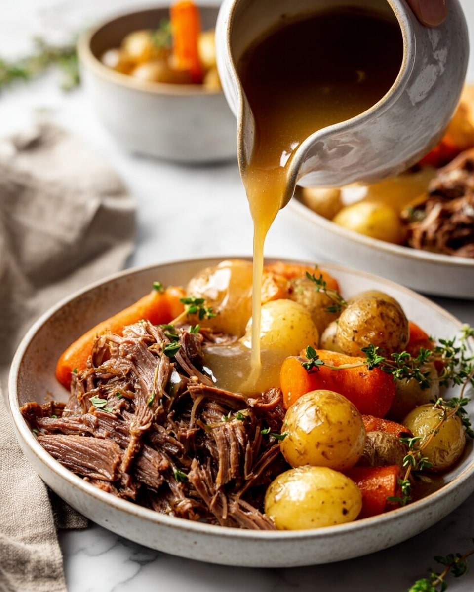 The dish is served in a white bowl filled with two main layers. The bottom layer has small golden potatoes, bright orange carrot sticks, and translucent cooked onion pieces arranged evenly. On top of this sits a layer of shredded brown meat with a glossy sauce that adds shine. Green herb sprinkles are scattered over the meat for color. A silver fork rests on the right side of the bowl, partially inserted in the meat. The bowl sits on a white marbled surface. photo taken with an iphone --ar 4:5 --v 7
