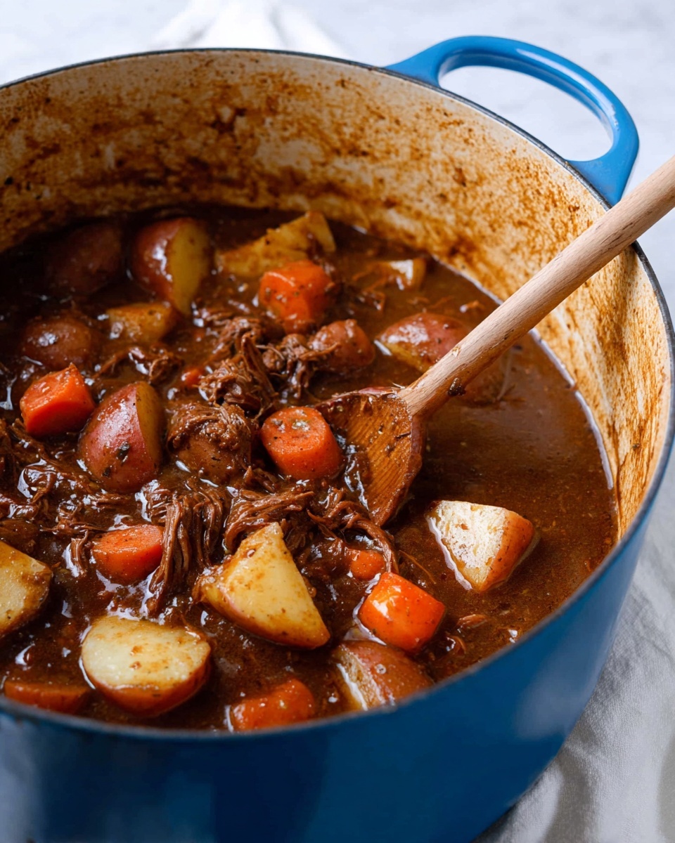 A close-up image of a thick stew inside a large blue pot, filled with chunky pieces of red potato with creamy white centers and bright orange carrot slices, all coated in a rich dark brown sauce that looks smooth and hearty. A wooden spoon is stirring the stew, showing shredded pieces of meat mixed in with the vegetables, and some bits of the sauce stick to the sides of the pot showing a slightly textured surface. The pot sits on a white marbled surface with a white cloth partially visible below it. The photo taken with an iphone --ar 4:5 --v 7