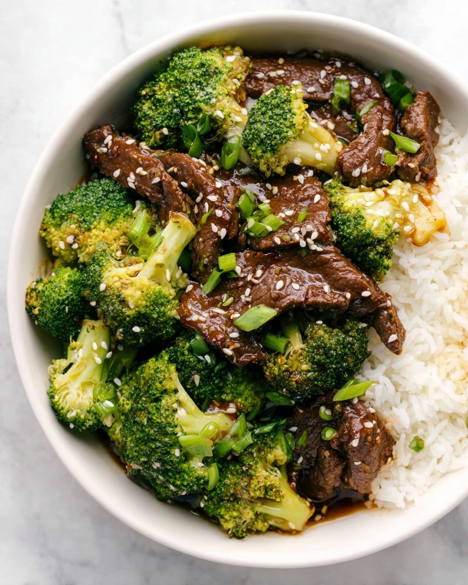 The image shows a white bowl filled with three main layers: at the bottom and right side, white steamed rice with soft texture, then brightly green broccoli florets with a slightly rough texture spread over the rice, and on top, slices of brown cooked beef coated in dark sauce. The beef and broccoli are sprinkled with small beige sesame seeds and thin slices of fresh green onions scattered across. The bowl rests on a white marbled surface with a piece of blue-grey cloth partially visible below the bowl photo taken with an iphone --ar 4:5 --v 7