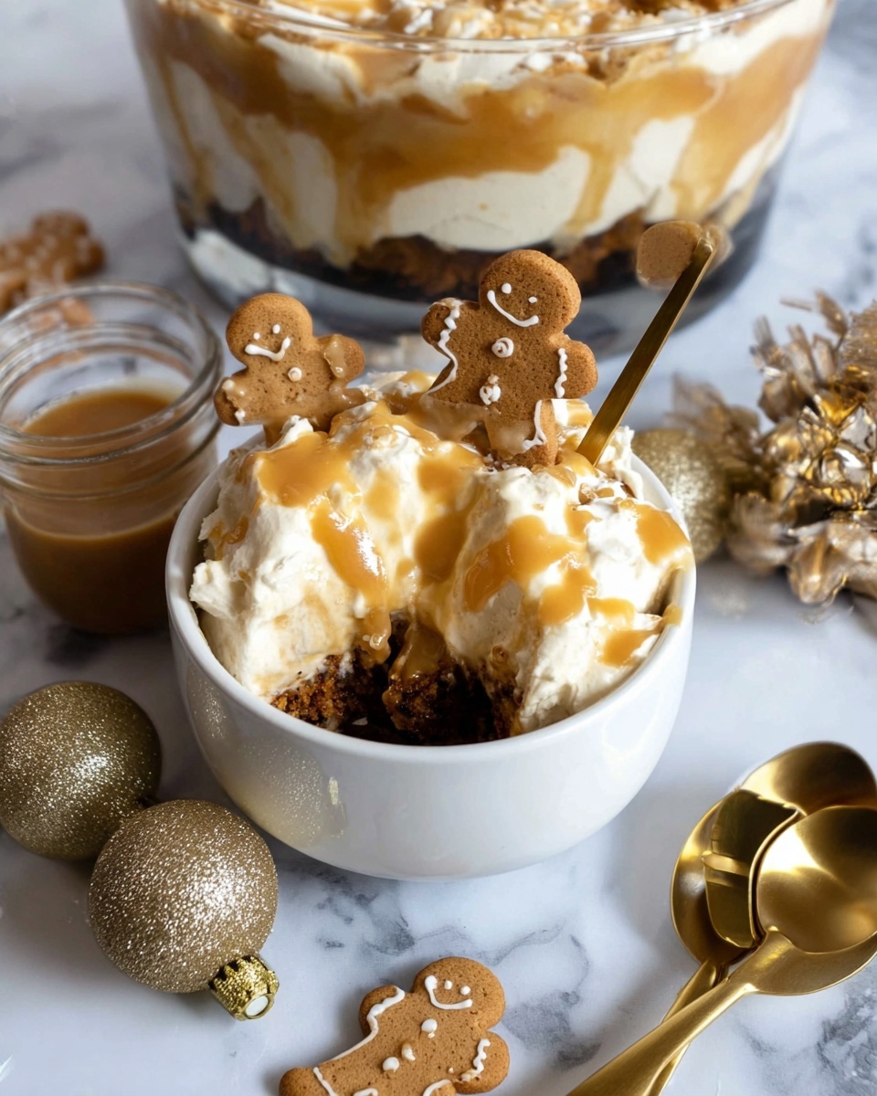 A small white bowl filled with a layered dessert starting with a dark brown crumb base at the bottom, topped with a fluffy light cream layer, and drizzled with a light caramel sauce. Two gingerbread man cookies with caramel sauce on top lay on the cream layer. A gold spoon rests inside the bowl. The bowl sits on a white marbled surface, surrounded by more gingerbread men cookies, two glittery gold Christmas ornaments, and gold measuring spoons. In the background is a larger glass bowl showing similar dessert layers and a small jar of caramel sauce. Photo taken with an iphone --ar 4:5 --v 7