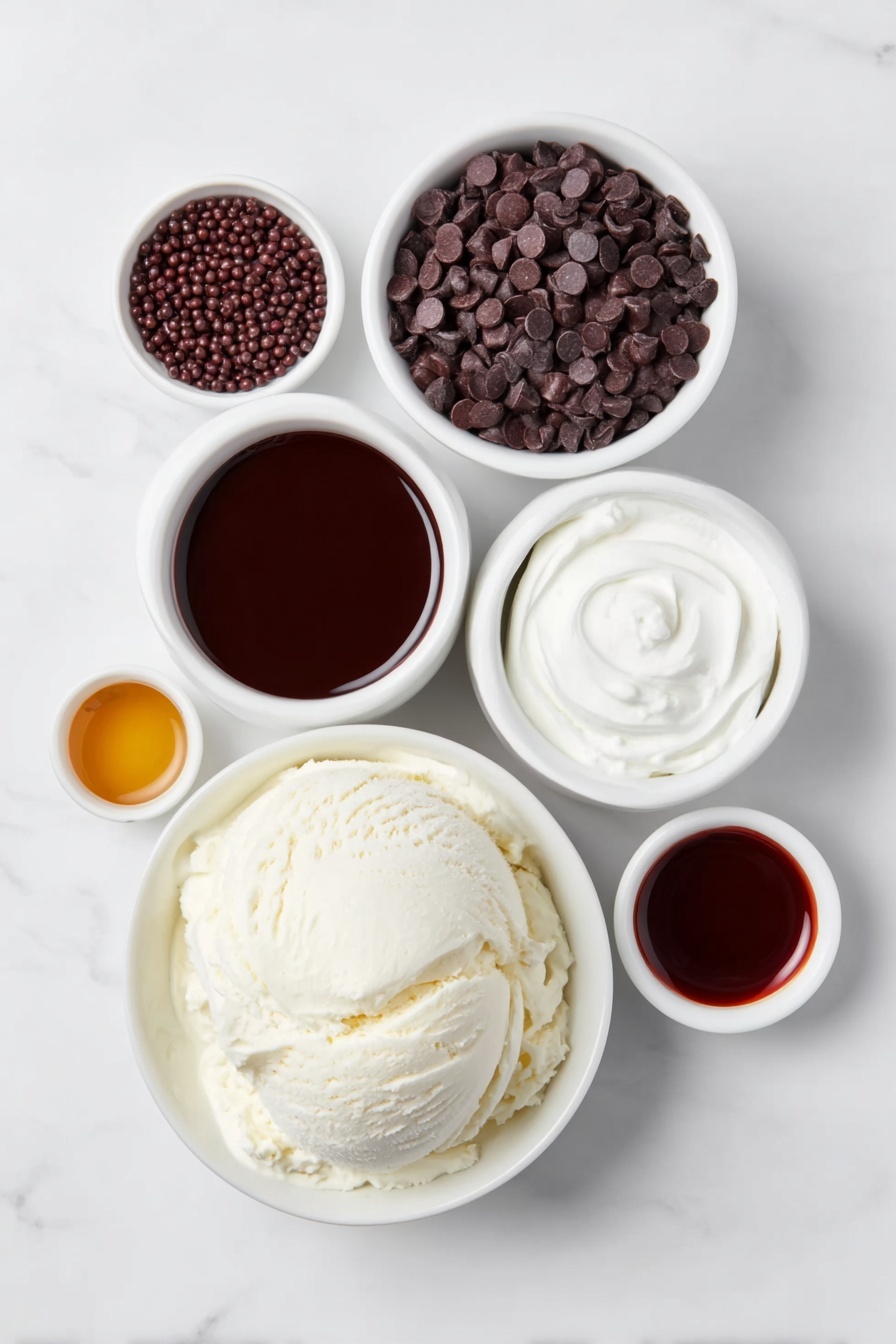 Flat lay of a large scoop of creamy vanilla ice cream on a simple white ceramic plate, a small white bowl filled with rich dark chocolate syrup, another small white bowl holding shiny chocolate sprinkles, a small white bowl with mini dark chocolate chips, a small white bowl containing smooth hot chocolate, a small white bowl with amber Kahlua liquor, and a small white bowl with deep brown dark creme de cacao liqueur, all arranged symmetrically and balanced on a clean white marble surface, soft natural light, photo taken with an iPhone, professional food photography style, fresh ingredients, white ceramic bowls, no bottles, no duplicates, no utensils, no packaging --ar 2:3 --v 7 --p m7354615311229779997 - Chocolate Hot Cocoa with Kahlua, Kahlua hot cocoa, indulgent chocolate drinks, easy winter beverages, coffee liqueur hot chocolate