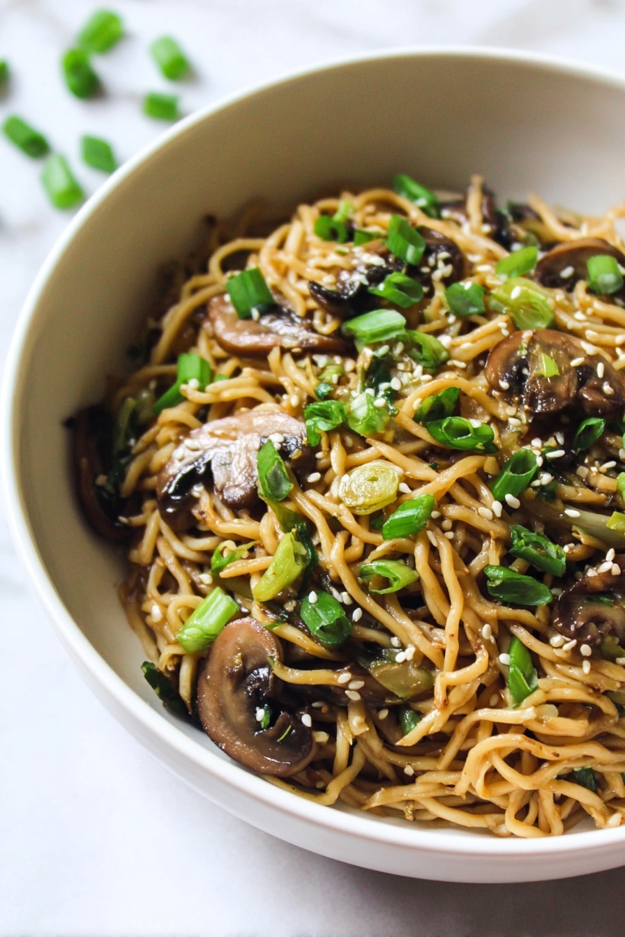 The image shows one white bowl filled with cooked noodles mixed with sliced brown mushrooms and chopped green onions. The noodles are light brown and slightly glossy, while the mushrooms are darker brown with a soft texture. The green onion pieces are vibrant green, scattered on top along with small white sesame seeds. The bowl is placed on a white marbled surface, creating a clean and bright background. Photo taken with an iphone --ar 2:3 --v 7 - Creamy Mushroom Ramen Noodles, mushroom ramen recipe, quick ramen dinner, savory mushroom noodle bowl, comforting mushroom ramen