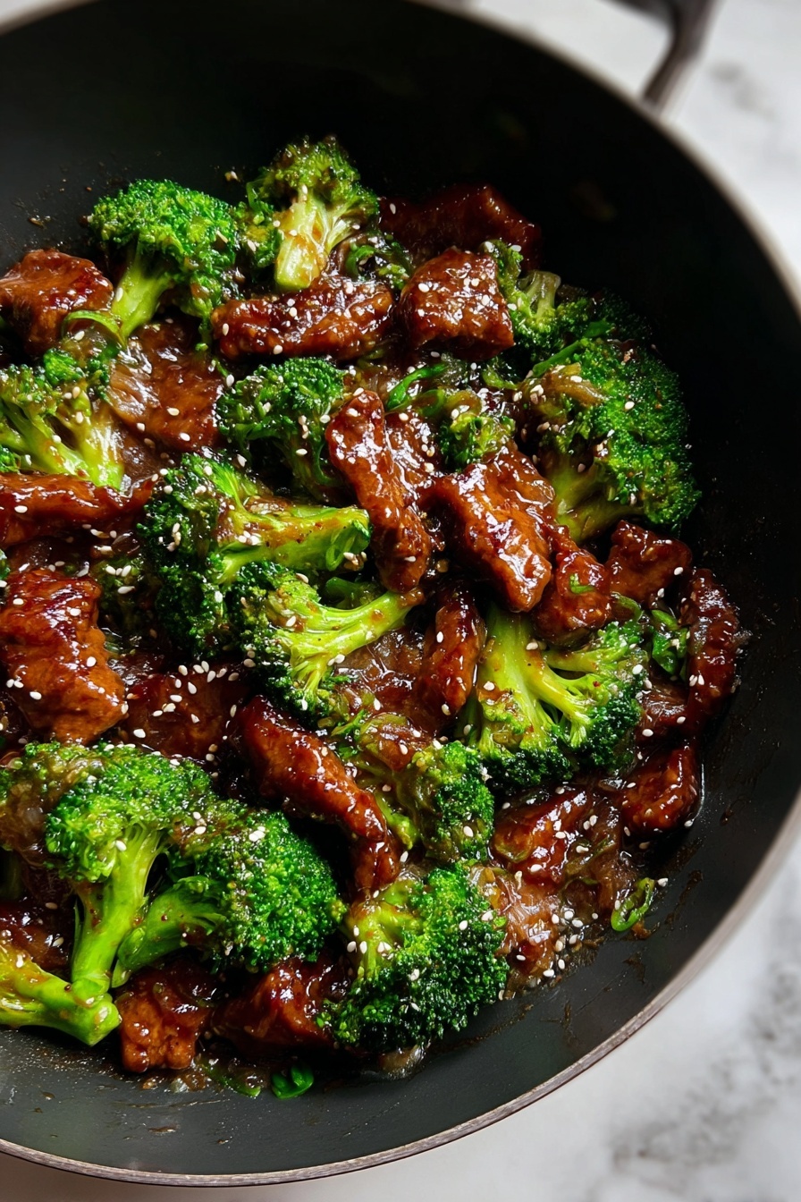 The dish shows about two layers mixed together in a black wok on a white marbled surface. The first layer is bright green broccoli florets that look fresh and slightly glossy. The second layer consists of shiny, brown pieces of meat coated in a thick sauce. Light-colored sesame seeds are sprinkled evenly on top, adding small spots of contrast. The sauce gives the meat a wet and glossy texture, while the broccoli adds a rough, natural look. The whole dish looks warm and tasty, with a good mix of colors and textures. Photo taken with an iphone --ar 2:3 --v 7 - Beef with Garlic Sauce, Chinese beef stir-fry, garlic sauce recipe, easy beef dinner, flavorful beef recipes