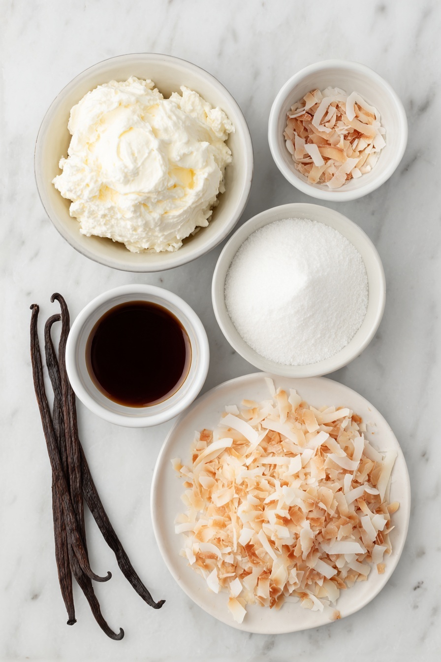 Flat lay of a small mound of cold heavy cream in a simple white ceramic bowl, a small white bowl filled with fine powdered sugar, a few whole brown vanilla beans beside a tiny white bowl holding vanilla extract, a larger white bowl containing cold full-fat coconut milk, a small white bowl with cold sweetened condensed milk, a tiny white bowl with coconut extract, and a neat pile of toasted unsweetened shredded coconut flakes on a white ceramic plate, all arranged symmetrically and naturally with fresh, unprocessed appearance placed on a clean white marble surface, soft natural light, photo taken with an iPhone, professional food photography style, fresh ingredients, white ceramic bowls, no bottles, no duplicates, no utensils, no packaging --ar 2:3 --v 7 --p m7354615311229779997 - Homemade Coconut Ice Cream, coconut ice cream, tropical ice cream, dairy-free coconut dessert, creamy coconut ice cream