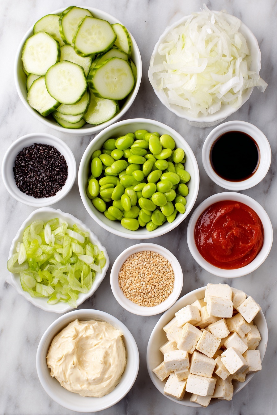 Flat lay of a whole fresh cucumber sliced into thin rounds, a small white ceramic bowl of thinly sliced white onion, a generous handful of golden crispy baked tofu cubes, a small white bowl filled with shelled bright green edamame, a white bowl with thin julienned orange carrot sticks, a small pile of sliced green spring onion, neatly cubed half avocado with vibrant green flesh, a small white bowl containing creamy vegan cream cheese, another small white bowl holding smooth vegan mayo, a small white bowl with bright red Sriracha sauce, a tiny white bowl filled with glossy chili-crisp oil, a small white bowl of dark soy sauce, a small white bowl scattered with light tan sesame seeds, and a small white bowl with delicate dark green crushed nori flakes, all perfectly arranged in balanced symmetry on a clean white marble surface, soft natural light, photo taken with an iPhone, professional food photography style, fresh ingredients, white ceramic bowls, no bottles, no duplicates, no utensils, no packaging --ar 2:3 --v 7 --p m7354615311229779997 - Creamy Asian Cucumber Salad Bowl, Asian cucumber salad, healthy cucumber salad, vegan Asian salad, quick Asian salad